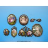 Four brooches each inset with painted shell decorated with various scenes including a couple,