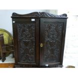 A Victorian carved oak campaign cupboard with flush brass folding handle (h78cm x w72cm x d19cm)