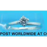 A 9ct white gold ring set with a round brilliant cut diamond (size M)