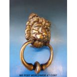 A vintage brass lion mask door knocker