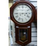 A drop-dial wall striking clock by the USA Waterbury Clock Co with mahogany case,