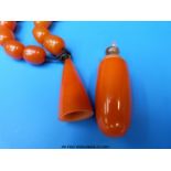 Two scent bottle pendants as necklaces, simulated ivory and amber,