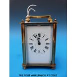 A brass cased carriage clock with enamel face,