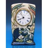 A Moorcroft mantel clock in the Lamia pattern (15cm tall)