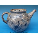 An earthenware teapot, cream slip with cobalt blue brushwork and incised signature,