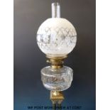 A late 19thC / early 20thC brass oil lamp with globe-shaped shade,