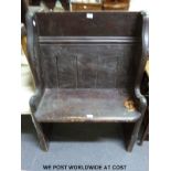 A stained pine two-seater pew / settle (h110cm x w78cm x d43cm)