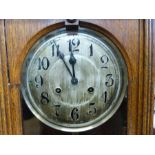 A c1920s oak-cased wall clock,
