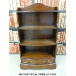 A mahogany waterfall bookcase with drawer under (h108cm x w63cm)