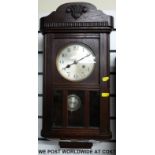 A two train c1910 wall clock complete with pendulum and key