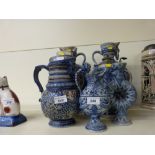A pair of Mettlach style Bavarian embossed jugs/vases together with five others, one lidded,