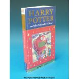 'Harry Potter and the Philosopher's Stone' with facsimile Rowling signature on the first page.