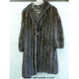 A three-quarter length, lined, vintage fur coat labelled Chas.