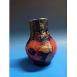 A Moorcroft vase in the Pomegranate pattern, 12cm tall.