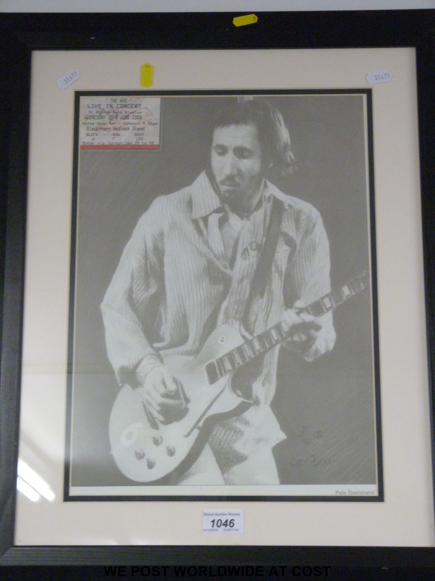 A framed picture of Pete Townshend (19" x 23") together with a concert ticket for 'The Who' at