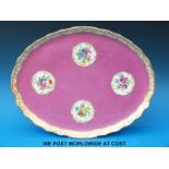 An oval ceramic tray with floral cartouches and Vienna beehive mark to base (42cm long)