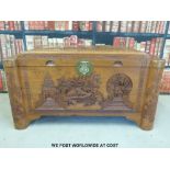 A Chinese camphor wood carved elm lined chest featuring a fisherman,