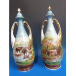 A pair of hand-painted urns decorated with cattle (40cm tall)