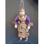 An Indonesian carved wooden puppet in traditional dress (40cm tall)