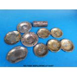 Nine Japanese pewter and gilt metal trays all with embossed decoration of figures,