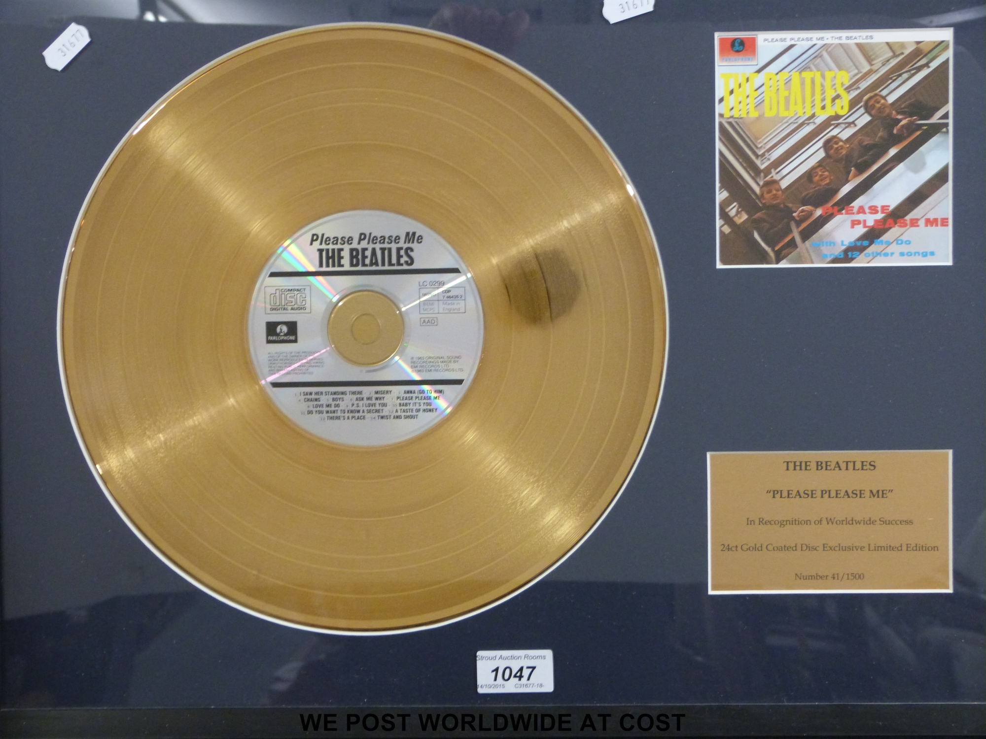 A framed (18” x 23”) “Gold” disc of The Beatles “Please Please Me” LP.