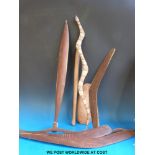 A collection of Aboriginal boomerangs, throwing clubs, snakes, hooked implement,