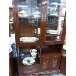 A Chinese dark elm display cupboard with glazed top diplay unit having asymmetric shelving over