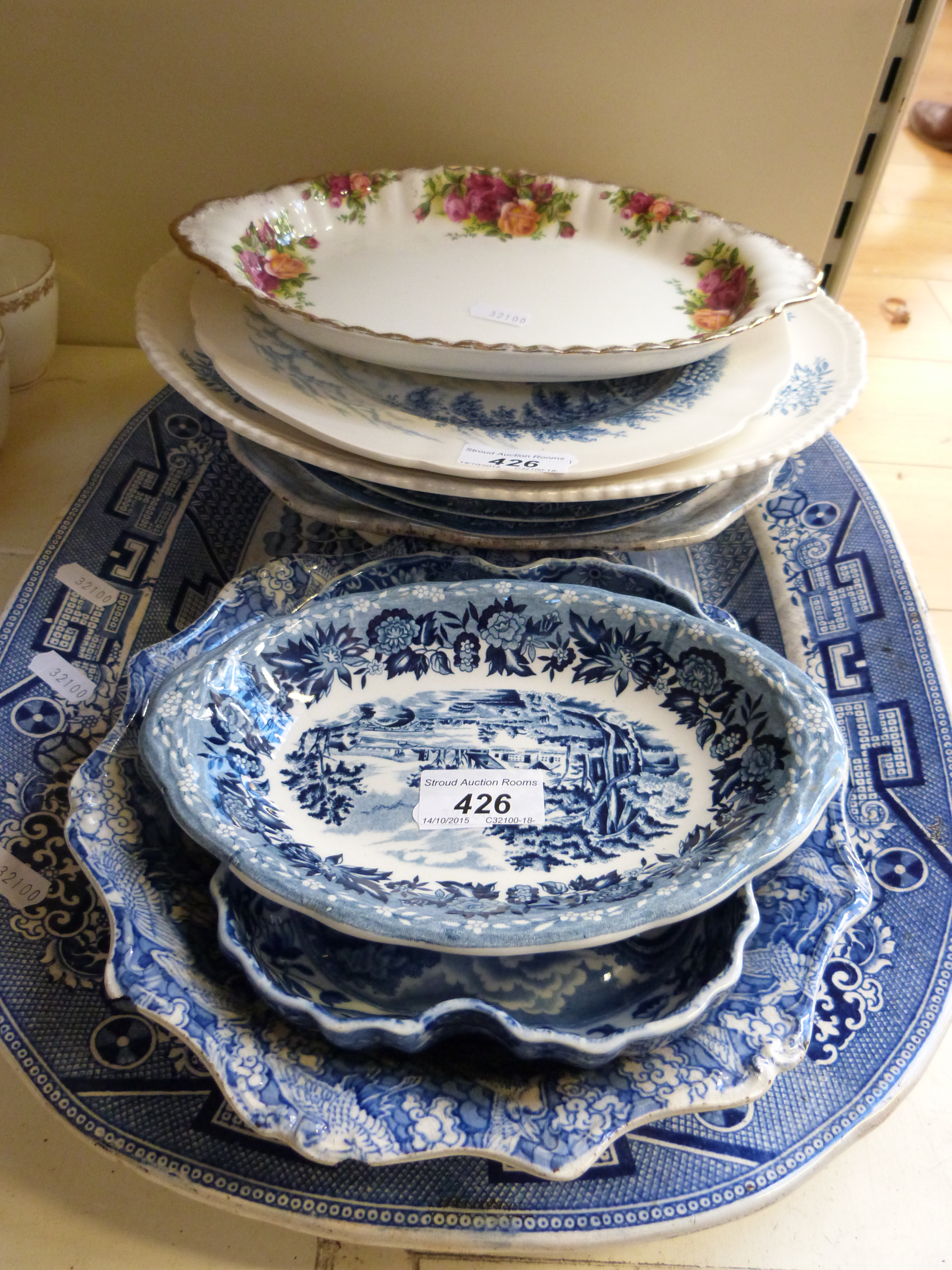 A quantity of blue and white ceramics to include a Willow pattern large platter,
