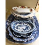 A quantity of blue and white ceramics to include a Willow pattern large platter,