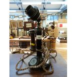A vintage candlestick telephone with bakelite fittings,