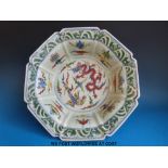 A Chinese octagonal bowl with scalloped and fluted edge and dragon and phoenix decoration (37cm