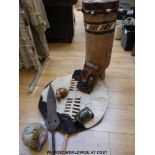 A collection of African artefacts including a shield, drum,