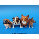 Two small Beswick and two small Doulton dogs,