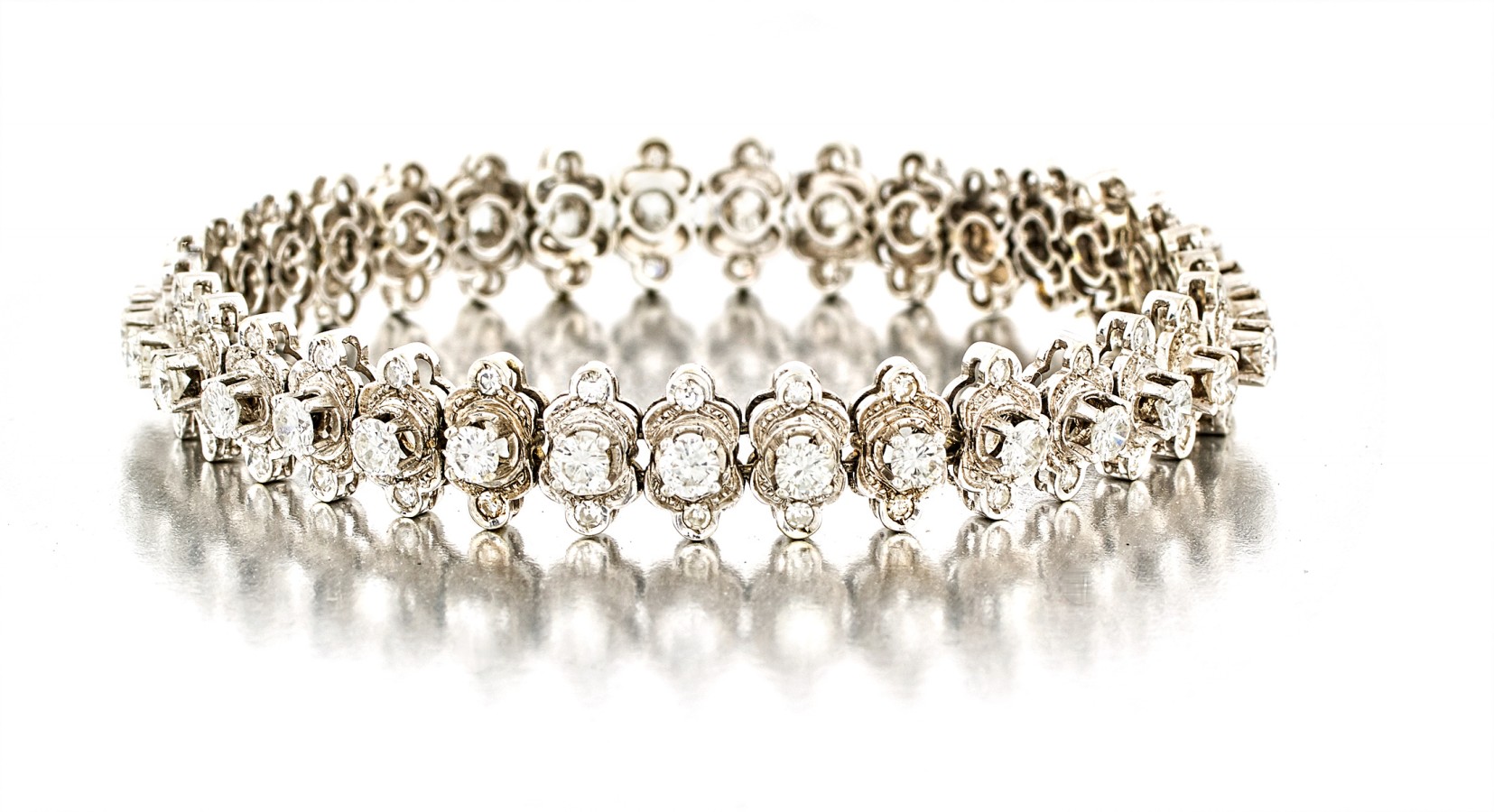 Diamond bracelet composed of double trefoil links pavé-set with eight-cut diamonds, each centre