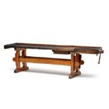 A yellowwood and fruitwood work bench, 19th century rectangular, with vice clamp and later drawer,