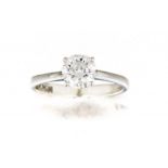 Diamond single-stone ring claw-set with a round brilliant-cut diamond weighing approximately 0.97