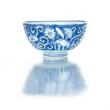 A Chinese provincial blue and white bowl, 18th century painted with flowers and scrolling foliage,