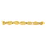 18ct gold bracelet composed of three woven and plaited strands divided by plain spacers, length