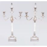 A pair of silver-plate three-light candelabra, 19th century each Corinthian column raised on a
