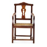 A Cape stinkwood armchair, 19th century the shaped rectangular top-rail above a pierced vase-