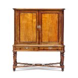 A Cape yellowwood and stinkwood cupboard-on-stand, early 19th century the outset cornice above a