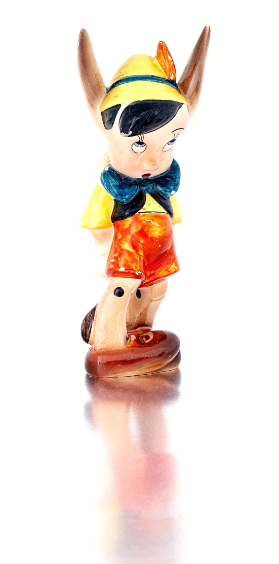 An Italian earthenware figure of Pinocchio, Ugo Zaccagnini, mid 20th century the standing figure