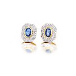 Pair of sapphire and diamond earrings collet-set to the centre in yellow gold with an oval