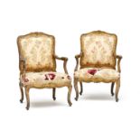 A pair of George III style giltwood and upholstered armchairs, 19th century the frame carved with