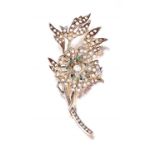 Victorian diamond and emerald brooch designed as a flower, the flowerhead set en tremblant, set to