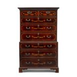 An Edwardian mahogany and inlaid chest-on-chest the moulded outset cornice above a pair of short