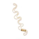 Cultured pearl necklace opera length, each pearl measuring approximately 7.00mm, to a gold spacer