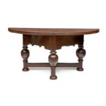 An oak gateleg table, 18th century and later the oval hinged top above a wave-shaped apron, on