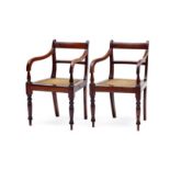 A pair of Cape stinkwood armchairs, 19th century each with curved top- and mid-rails, downcurved