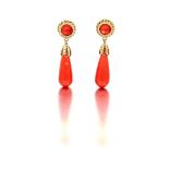 Pair of coral drop earrings "composed of a collet-set cabochon coral enclosed by double rope-twist